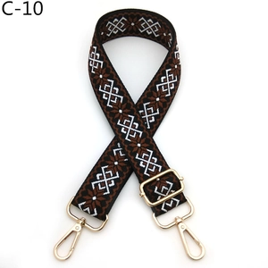 Close-up of geometric jacquard bag strap with gold metal lobster hooks and buckle