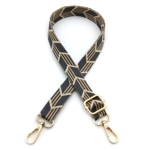 Detail of adjustable geometric arrow pattern bag strap with gold lobster clasps