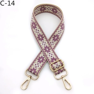 Detail of adjustable geometric strap with purple ice flower pattern and gold hooks