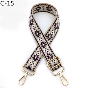 Detail of adjustable woven strap with purple snowflake patterns and gold metal hooks