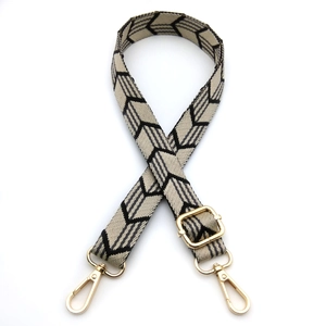 Close-up of arrow pattern woven strap with adjustable golden metal lobster clasps