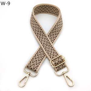 Adjustable wide shoulder strap with brown and beige wave pattern and gold metal hardware