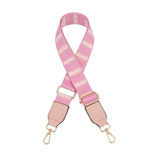 Detail of pink adjustable guitar style strap with wave pattern and golden lobster clasps