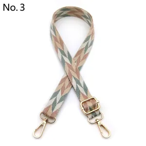 Adjustable wide woven shoulder strap with leaf pattern and gold metal hooks