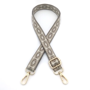 Detail of adjustable geometric diamond pattern shoulder strap with gold swivel hooks