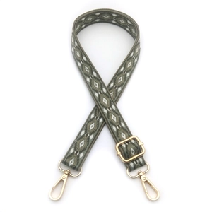 Close-up of adjustable woven strap with green diamond pattern and gold metal lobster clasps