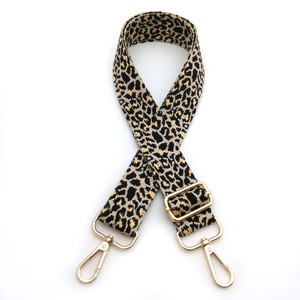 Adjustable leopard jacquard shoulder strap with gold metal hooks and buckle on white background