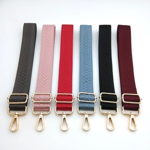 Adjustable crossbody shoulder straps with herringbone pattern and gold metal hardware