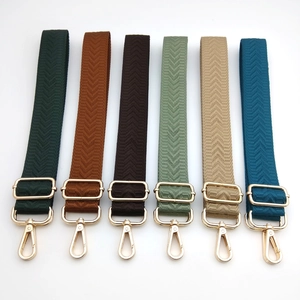 Adjustable crossbody shoulder straps with herringbone weave and gold metal hardware