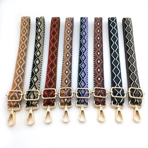 Detailed view of eight bohemian geometric jacquard woven bag straps with gold metal hooks