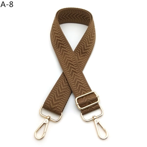 Brown woven shoulder strap with arrow pattern and light gold metal lobster clasps