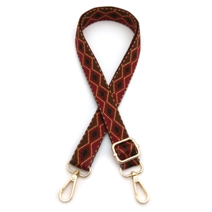 Close-up of geometric diamond pattern woven shoulder strap with gold swivel lobster clips