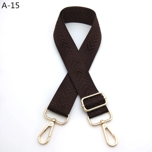 Close-up of brown herringbone woven strap with gold metal hooks and adjustable buckle