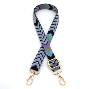 Adjustable woven shoulder strap with geometric fishbone pattern and gold metal buckles