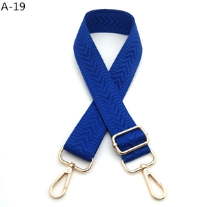 Detail of royal blue chevron woven strap with adjustable golden metal hardware