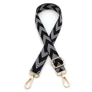 Adjustable black and white herringbone bag strap with polished gold lobster clasps