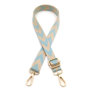 Detail of adjustable beige and light blue herringbone woven strap with gold metal hooks