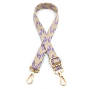 Detail of adjustable woven bag strap with purple chevron pattern and gold metal hooks