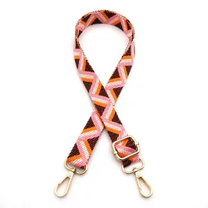 Detail of Style 12 woven shoulder strap with geometric patterns and gold metal buckles