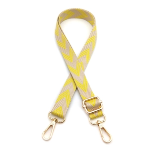 Detail of beige and yellow herringbone woven strap with gold metal lobster clasps