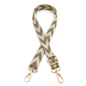 Detail of adjustable brown and beige chevron pattern strap with gold lobster clasps