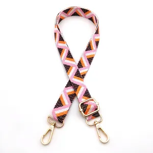 Close-up of pink and orange geometric zigzag strap with gold adjustable metal hardware