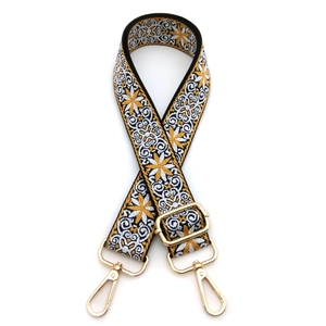 Close-up of adjustable ethnic style woven bag strap with yellow floral patterns and gold hooks
