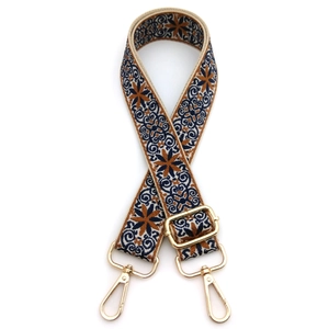 Close-up of ethnic style embroidered bag strap with floral pattern and gold hooks