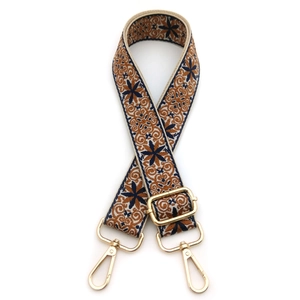 Detail of adjustable ethnic style woven strap with floral patterns and gold lobster clasps