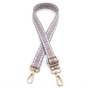 Adjustable woven strap with grey pink geometric pattern and gold swivel lobster clasps
