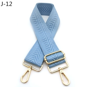 Detail of light blue chevron pattern strap with gold metal lobster clasps and hardware