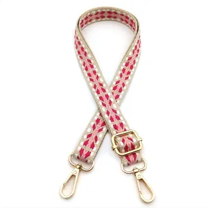 Adjustable woven bag strap with pink and beige ethnic geometric patterns and gold clips