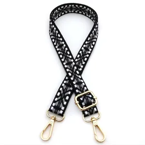 Detail view of woven bag strap in geometric pattern with golden lobster clasps, Style No. 10