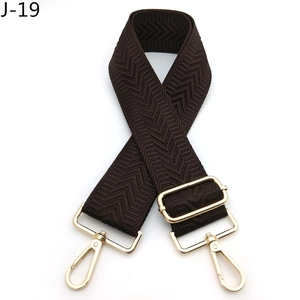 Detail of wide coffee brown chevron pattern bag strap with adjustable gold lobster clasps