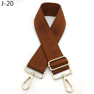 Close-up of brown adjustable guitar style shoulder strap with gold swivel snap hooks