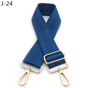 Close-up of navy blue arrow patterned bag strap with durable gold metal hardware detail