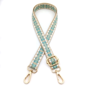 Ethnic style embroidered shoulder strap with green geometric patterns and gold clips