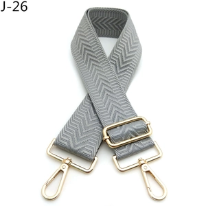 Close-up of grey chevron woven replacement strap with adjustable gold metal buckle
