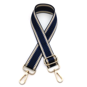 Close-up of geometric arrow pattern strap with polished gold-tone metal lobster clasps