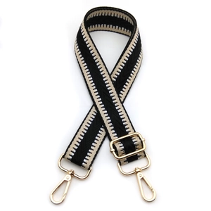 Adjustable woven shoulder strap with geometric chevron pattern and gold metal buckles