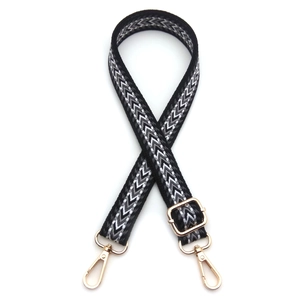 Close-up of adjustable chevron woven strap with golden lobster clasps for handbags