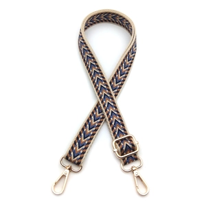 Detail view of 2.5cm jacquard bag strap with arrow pattern and gold metal hooks