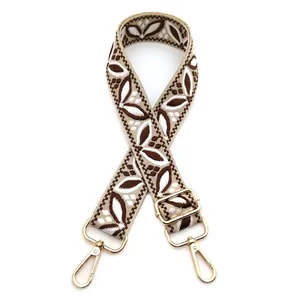 Detail of bohemian leaf pattern woven strap with premium gold metal swivel hooks