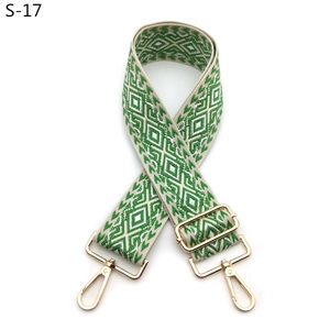 Detail of bohemian geometric jacquard bag strap with gold rotating metal hooks