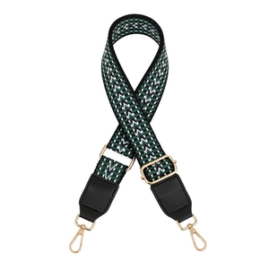 Close-up of adjustable woven shoulder strap with green geometric patterns and gold clips