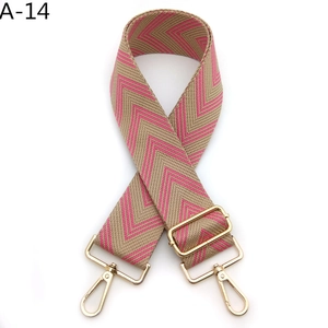 Detail view of thickened adjustable bag strap with pink chevron pattern and gold hooks