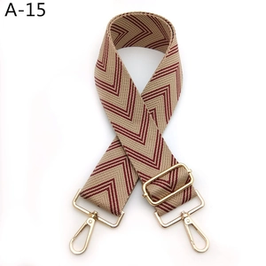 Detail of red-brown chevron woven bag strap with adjustable light gold metal buckles