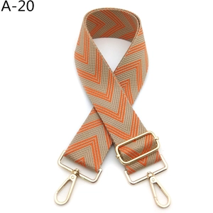 Detail view of adjustable beige and orange chevron strap with gold swivel hooks