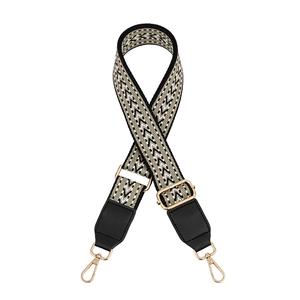 Adjustable woven strap with geometric patterns and gold metal swivel snap hooks
