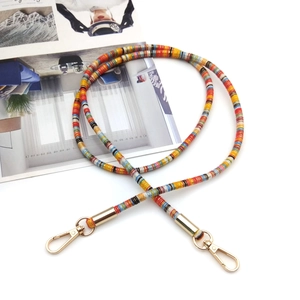 Ethnic style colorful beaded phone lanyard with golden lobster clasps on white background